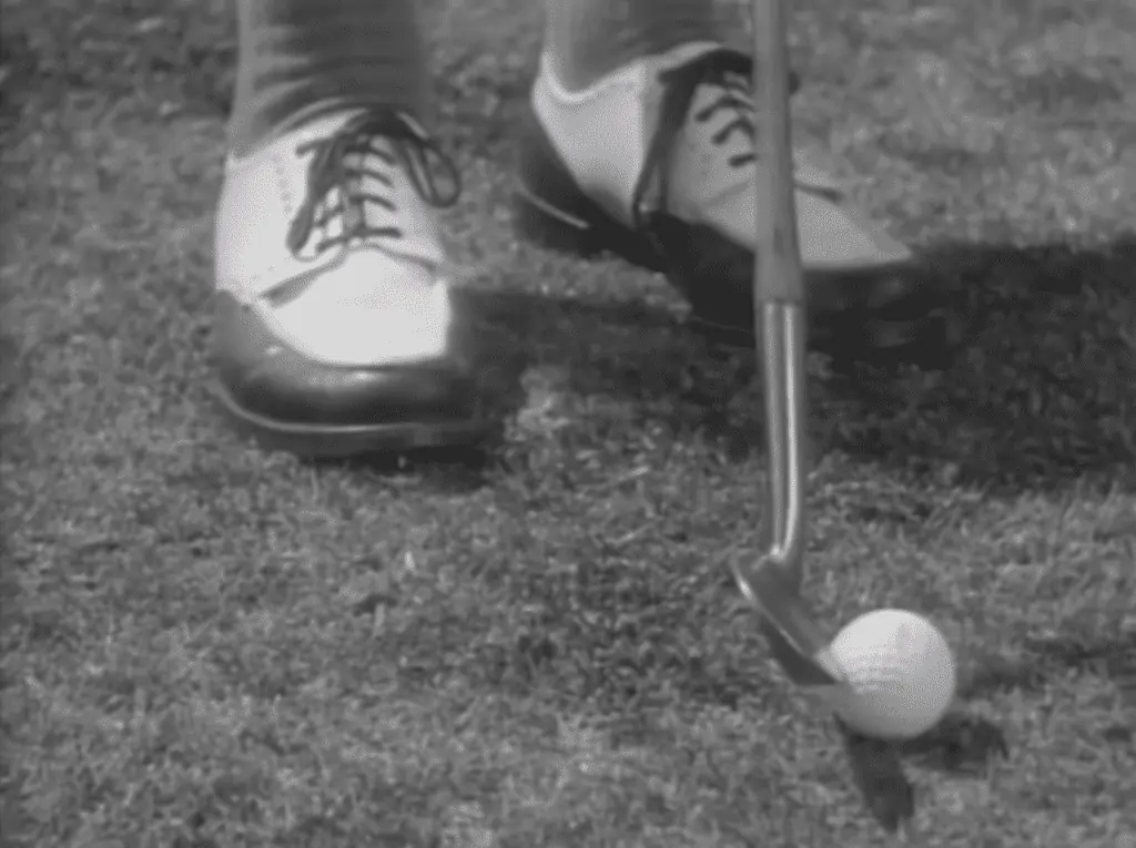 Bobby Jones golf clubs with the Mashie Niblick - showing his shoes, club, and ball close up.