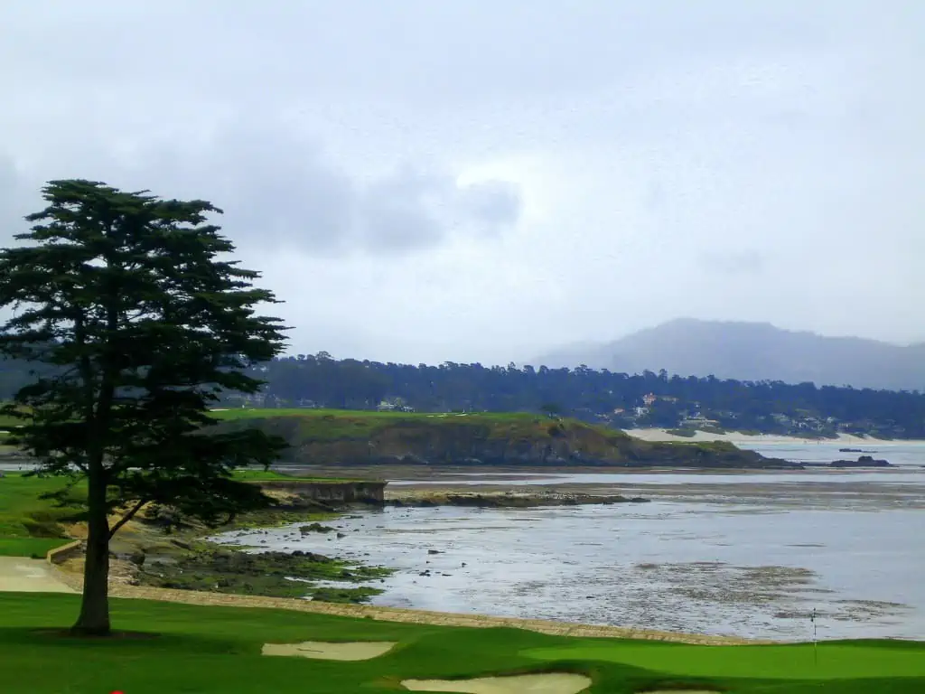 Green and view of Carmel Bay at Pebble Beach Golf Links 
