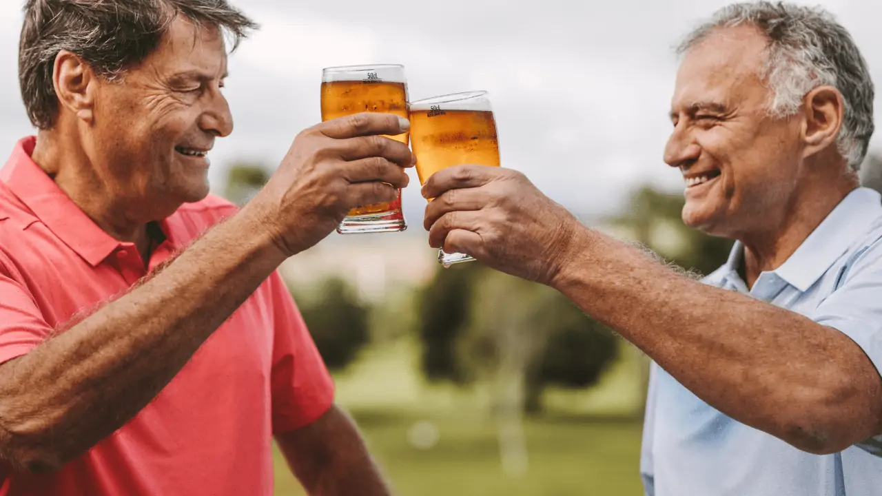 The 13+ Best Coolers for Golf Push Carts - two golfers enjoying a beer after their round of golf, beer coolers for golf push carts.