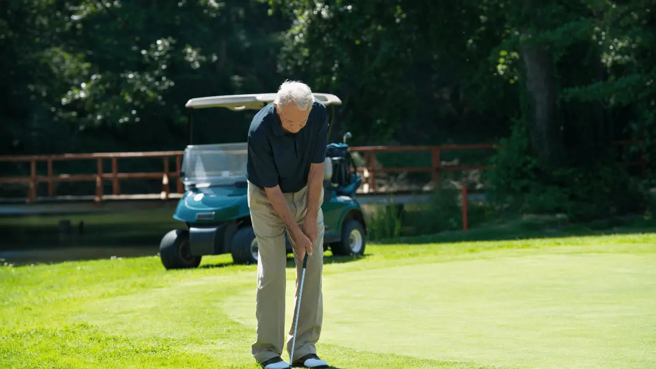 best short game tips for seniors - senior golfer setting up for a chip shot.