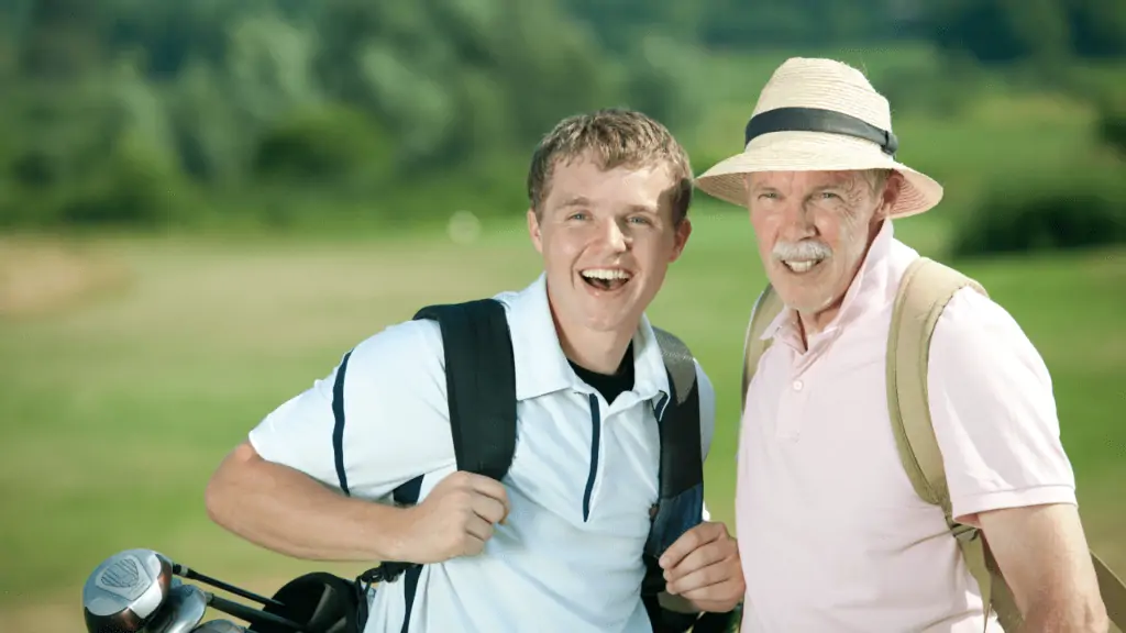 two golfers, one kid and a adult male wearing a golf sun hat.