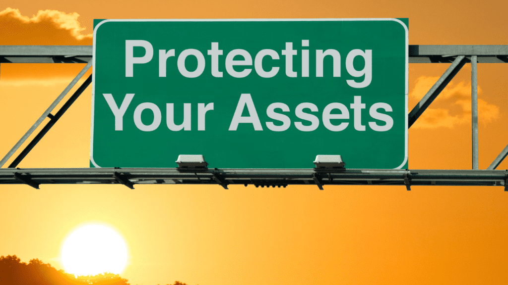sign reads "protecting your assets" with sun in the background.