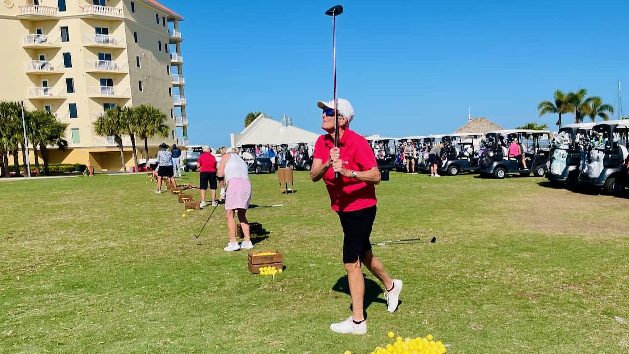 Ladies senior golfer, Carol Johnson warming up at the driving range on Isla Del Sol Golf Course