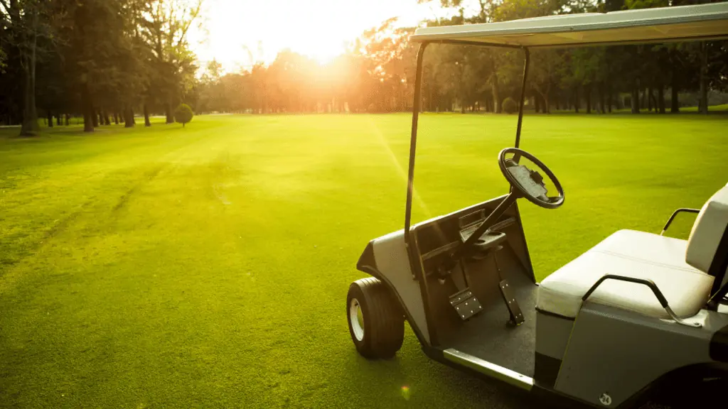 beautiful sunset photo with golf cart on the fairway 