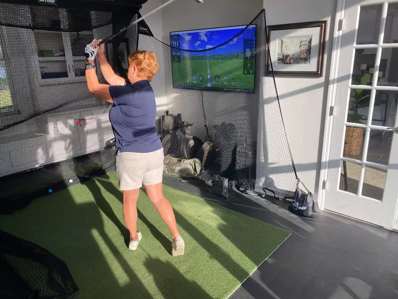 HackMotion Pro testing photo with senior golfer on a golf simulator