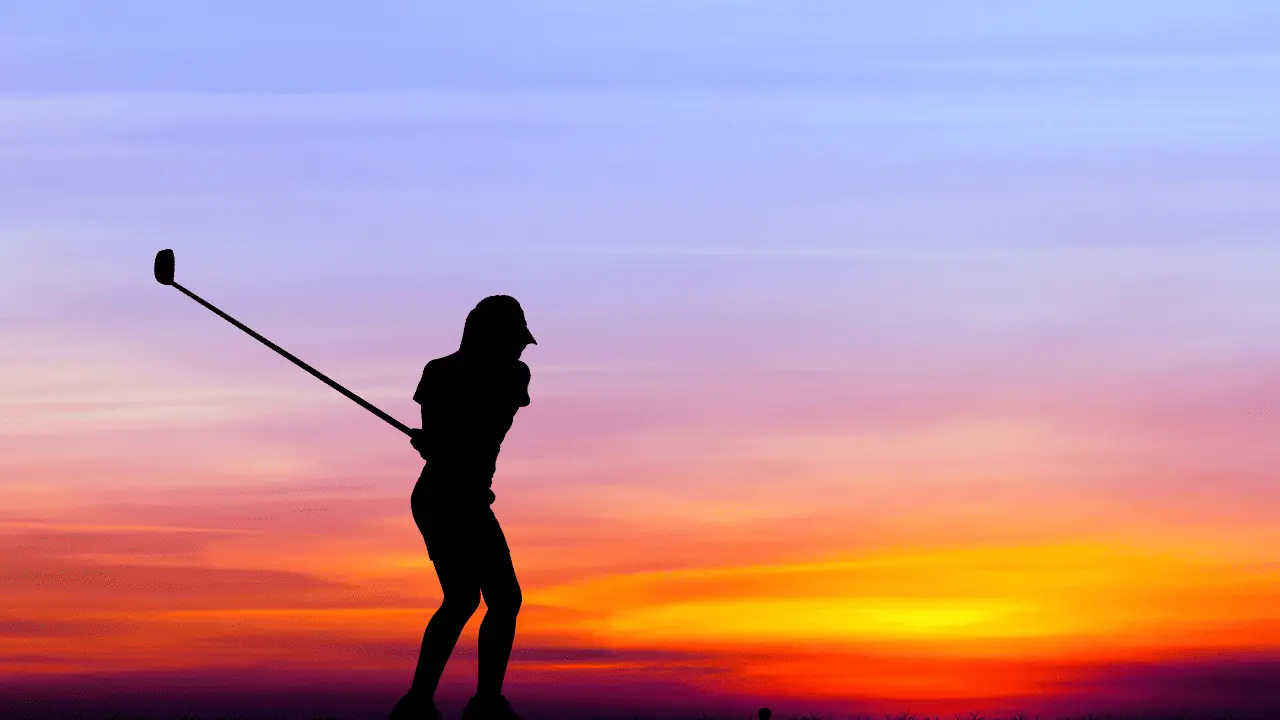 golfer silhouette into a sunset