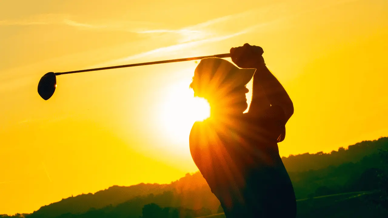 golfer hitting into the sunset.