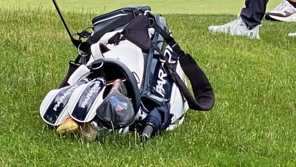 Showing Rod Pampling what's in the bag photo of his golf bag with Paradym written on the side lying on the grass on the En-Joie Golf Course in 2023