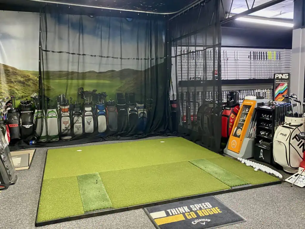 showing a club fitter shop with a golf simulator, a club fitter can help with fitting the best used golf clubs for you.