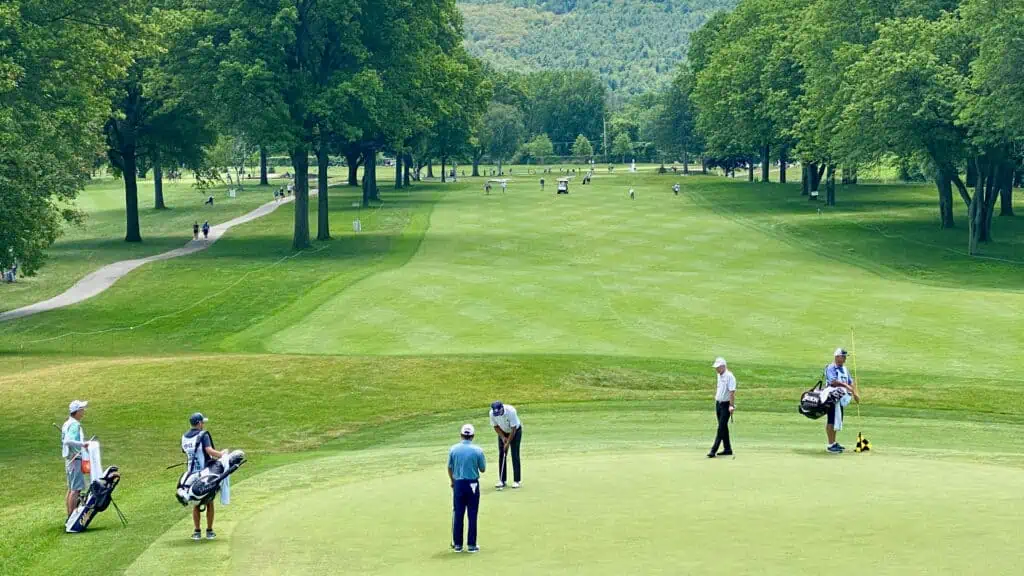 Pro golfers playing on the Senior Tour on the green on the En-Joie Golf Course in New York
