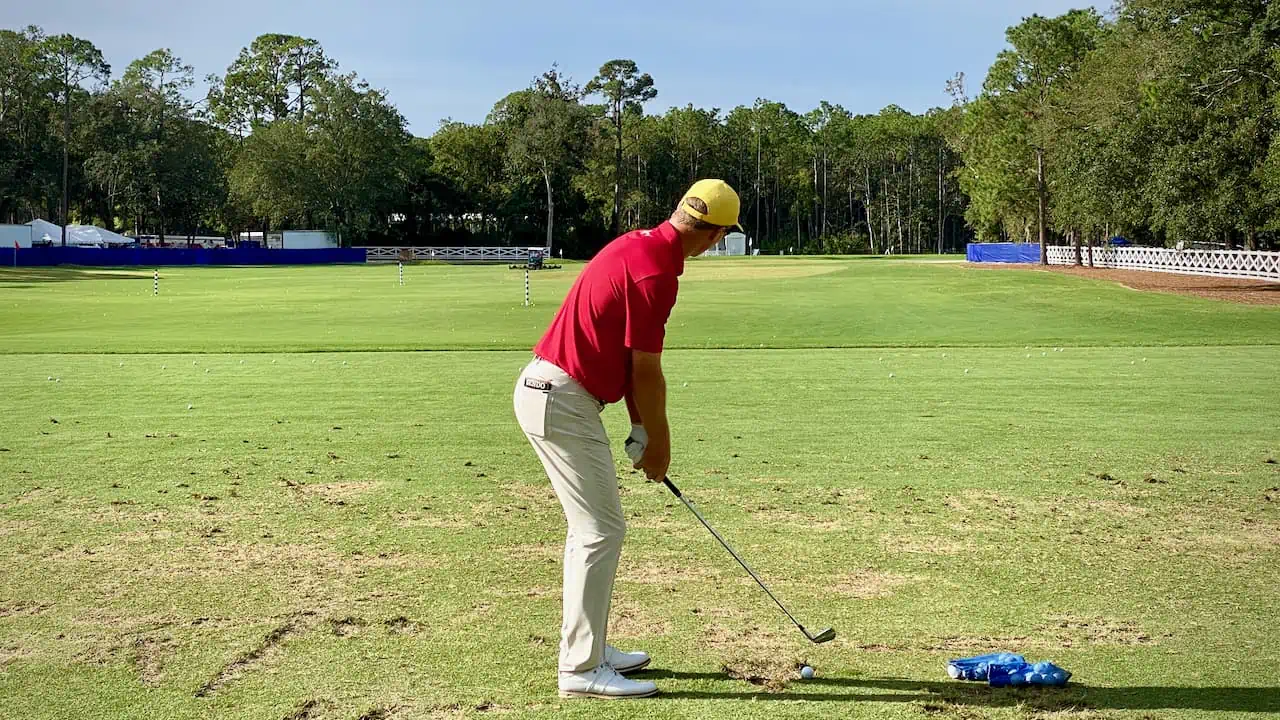 Senior golfer hitting his golf iron on the driving range in Florida by Senior Golf Source