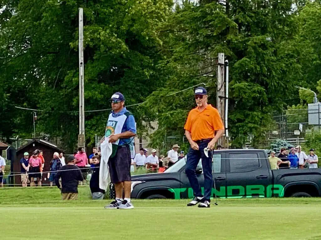 Dick's Sporting Goods Open with Miguel Angel Jimenez finishing with his putting and caddie, Alejandro next to him.