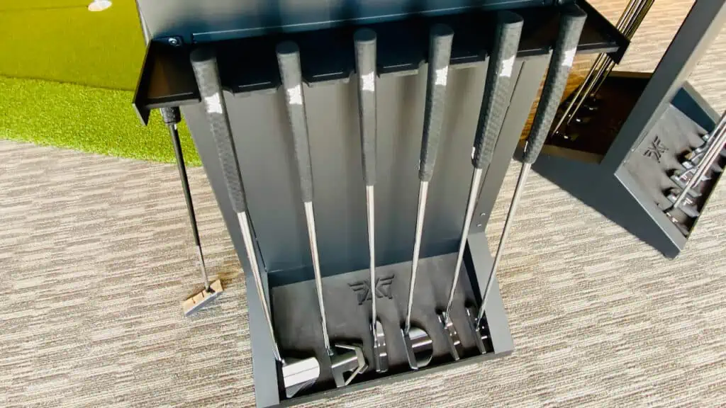 showing the types of putters in a sales rack at PXG with mallet putters and blade putters.