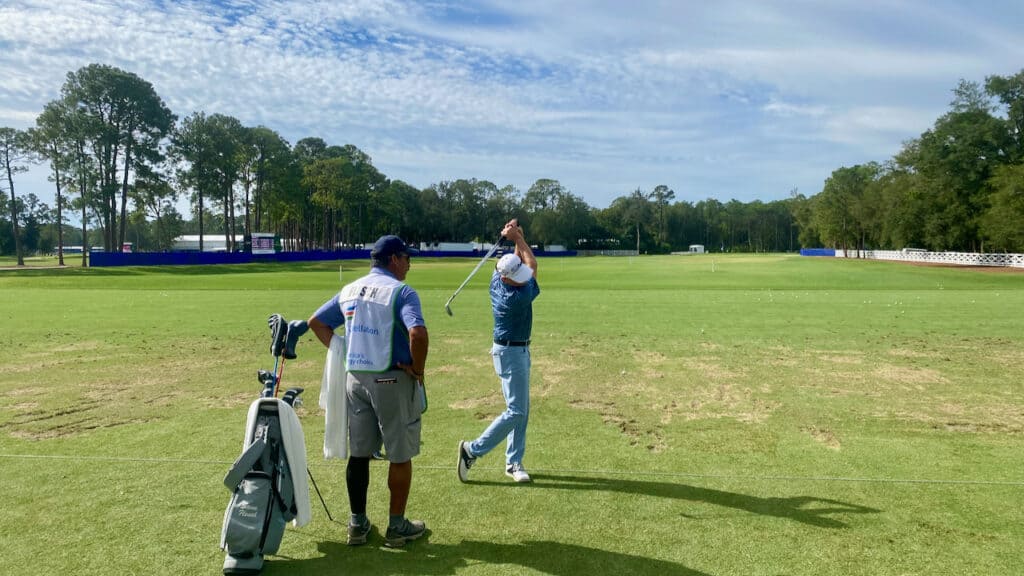 Steve Flesch with his caddie practicing his iron shot in 2023 in Jacksonville, FL.