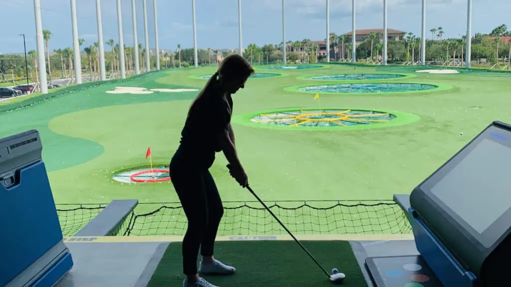 Erin Blakely doing her TopGolf Review by playing golf at TopGolf St Pete