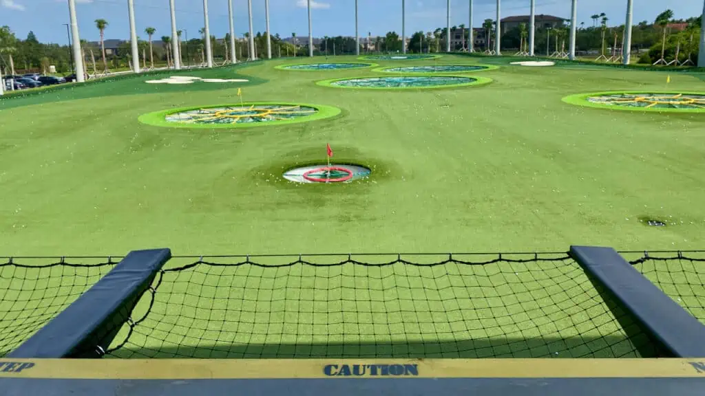TopGolf showing the 2nd floor bay with the caution sign for the drop off below.