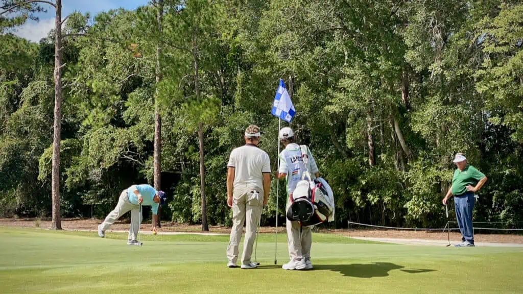 Bernhard Langer and caddie studying the 17th hole at the Furyk & Friends Tournament in 2023
