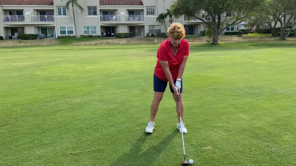 Senior golfer, Colleen with Senior Golf Source hits her golf hybrid in the fairway.