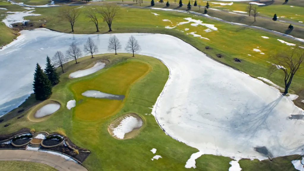 showing golf course in winter with snow on the course 