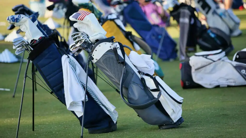 Photo of multiple golf bags on a driving range taken by senior golf source