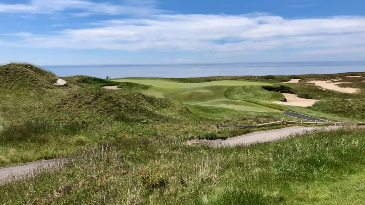 golf course photo of arcadia bluffs michigan with water in the background