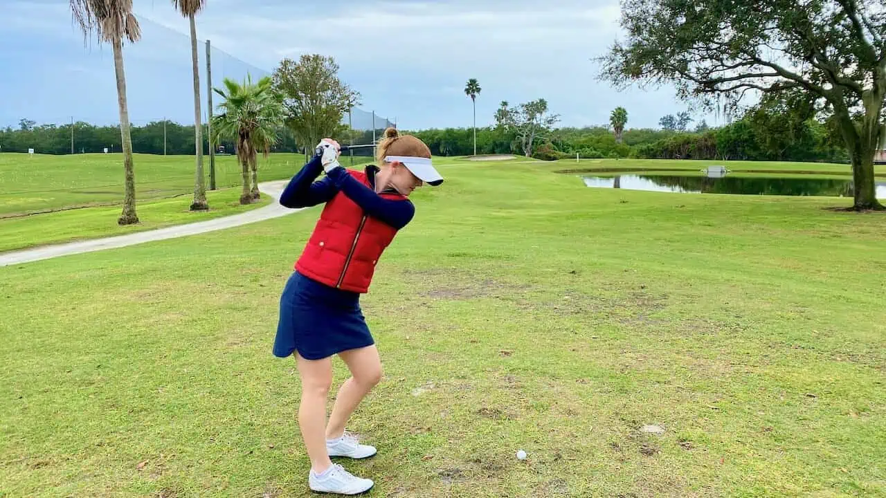 Erin with Senior Golf Source demonstrating golf course management for high handicappers by thinking about tee shot before hitting near the water ahead.