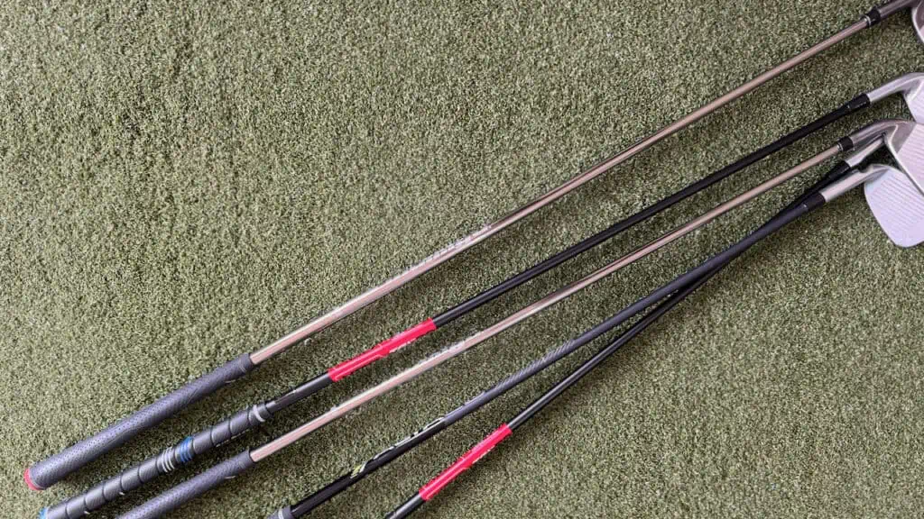 photo shows a variety of types of irons shafts on the ground