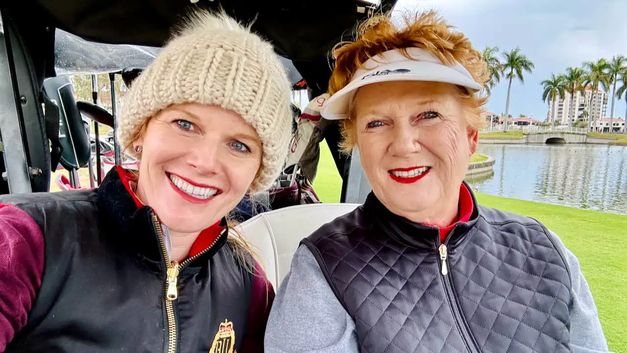 two women golfers shown golfing in the winter.