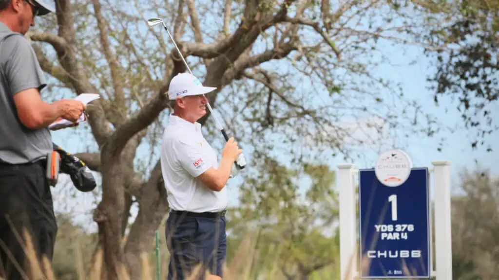 Ernie Els photo taken by Senior Golf Source at the Chubb Classic 2024.  He's hitting his iron from the tee box.