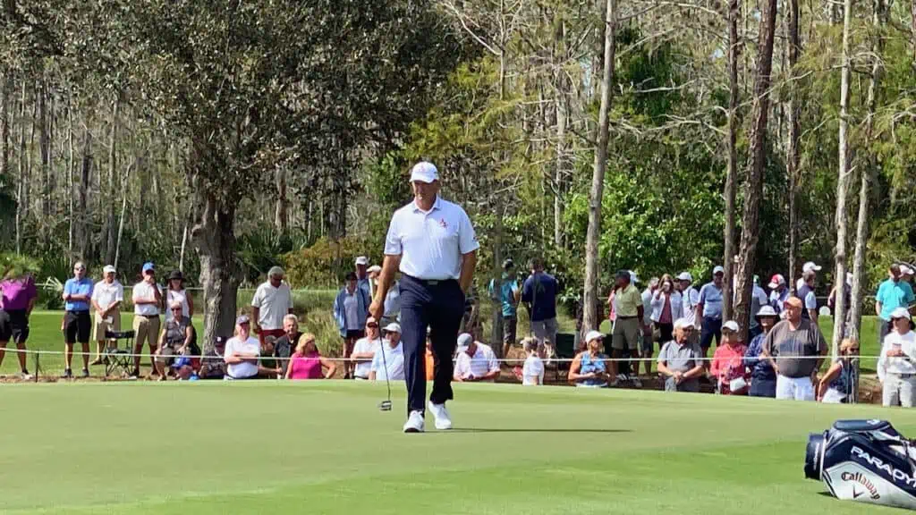 Goosen leaving the green at the Chubb Classic with his putter in hand.