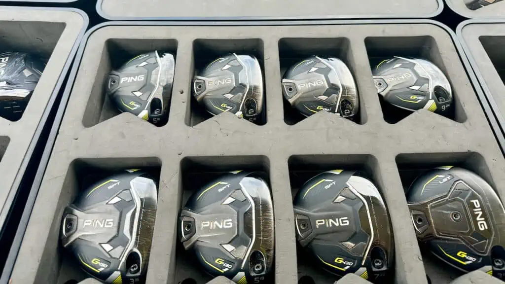 how to build golf clubs and showing a box of club heads for selection.